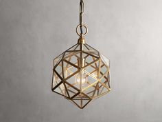 a light fixture hanging from the ceiling with an intricate geometric design on it's side