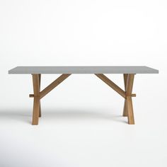 a white table with two wooden legs and a grey top, against a white background