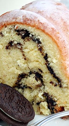 a close up of a slice of cake on a plate with an oreo cookie