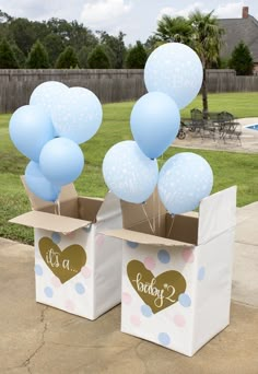 two boxes with balloons in the shape of hearts