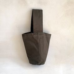 a brown bag hanging up against a white wall with no one in it or someone else