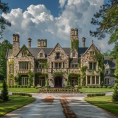 a large stone house surrounded by lush green trees