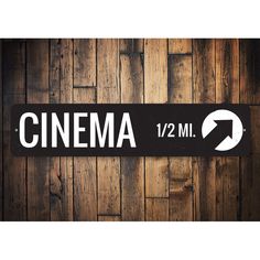 a wooden wall with a sign that says cinema and an arrow pointing to the right