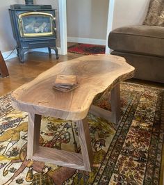 a wooden table sitting on top of a rug