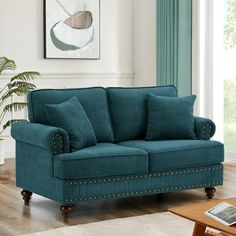 a living room with a blue couch and coffee table