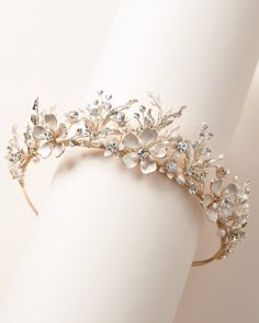 a gold tiara with crystal flowers and leaves