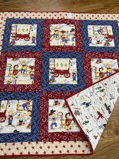 a red white and blue quilt on the floor