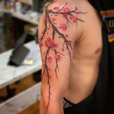 a man's arm with flowers on it