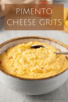 a white bowl filled with cheese grits on top of a wooden table