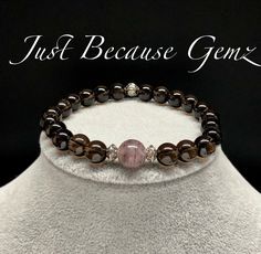 Strawberry Quartz and Smoky Quartz Gemstone Beaded Bracelet with silver spacers. Colors may vary due to your computer settings. See other listings for matching or stacking bracelets. Details Gemstones- Strawberry Quartz 10 mm/Smoky Quartz 8 mm Metals and spacer bead embellishments are lead free and nickel free. Bracelet cord is strong elastic pre-stretched cord, knotted and secured with adhesive glue. When possible, your beaded stretch bracelet will be threaded with two cords for added strength. Cherry Quartz Bracelet, Smoky Quartz Bracelet, Cord Bracelet Diy, Bracelet Cord, Ocean Inspired Jewelry, Healing Gemstone Bracelets, Stacking Bracelets, Headache Relief, Beads Bracelet Design