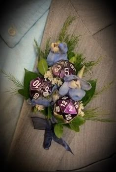 a boutonniere with blue flowers and dices on the lapel cover