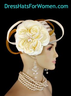 Ladies 1920's Style Flapper Art Deco Era Ivory Metallic Gold Pillbox Church Wedding Bridal Cocktail Hat. This Formal Straw Braid Hat Is Embellished With A Large Ivory Double Loop Bow Enhanced With Clear Acrylic Rhinestones, Accented With Two Metallic Gold Double Looped Bows. A Large Ivory Millinery Silk Flower With A Large Pearl Center Is Placed In The Center Of This Beautiful Custom Made Bow.  Four Rows Of Rhinestones Encircle The Crown Of This Fashion Wedding Headpiece. This Designer Hat Is Su Flapper Style Fitted Wedding Headpiece, Fitted Flapper Wedding Headpiece, Wedding Flapper Fitted Headpiece, Vintage Wedding Costume Hat With Pinched Crown, Adjustable Flapper Wedding Headpieces, Vintage Wedding Hat With Pinched Crown, Vintage Fitted Headpieces For Wedding, Vintage White Wedding Costume Hats And Headpieces, White Vintage Headpiece For Formal Occasions