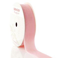 a roll of pink satin ribbon on a white background