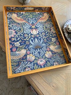 there is a tray that has flowers and birds on it