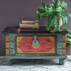 a potted plant sitting on top of a wooden chest