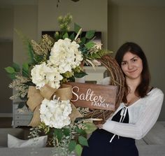 a woman standing next to a basket with flowers in it and the words satter family on it