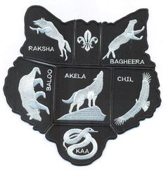 four embroidered patches depicting different animals and their names in white on black, with silver accents