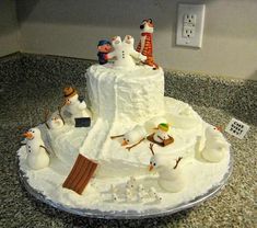 there is a cake that looks like it has snowmen on top and other decorations