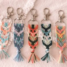 four key chains with tassels on them