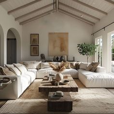 a living room filled with lots of white furniture