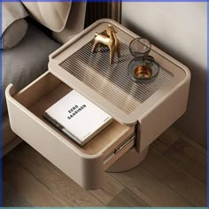 a table with a book, magazine and gold shoe on it next to a couch