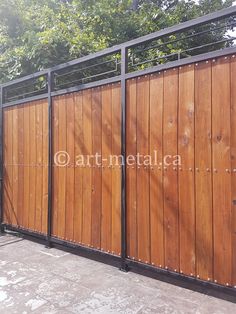 a wooden fence with metal posts and gates