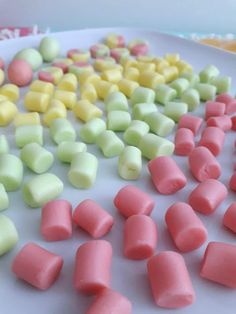 there are many different colored marshmallows on the plate