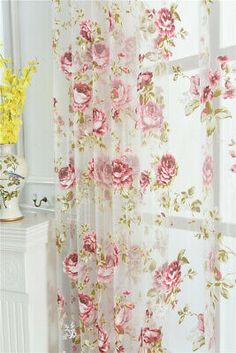 the curtains in this room have pink flowers on them