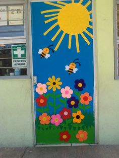 a painted door with flowers and bees in front of a building that has a window