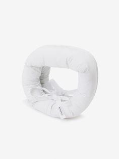 an inflatable white object sitting on top of a white floor next to a wall