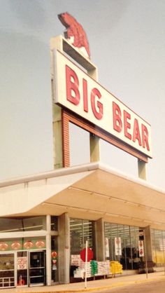 a big bear store sitting on the side of a road