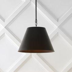 a black lamp hanging from a ceiling in a room