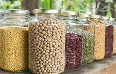 several jars filled with different types of beans