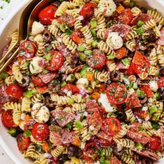 a bowl filled with pasta salad next to a fork