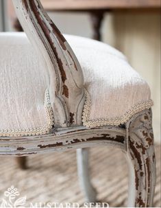 an old wooden chair sitting on top of a rug