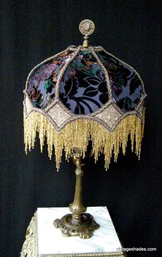 an ornate lamp is sitting on a table