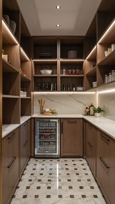 a kitchen with marble flooring and wooden cabinets in the center is lit by recessed lights