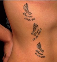 a woman's lower back with three footprints and the names of two people on it