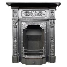 an ornate silver fireplace with carvings on the top and bottom part, against a white background