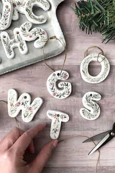 someone is making christmas ornaments out of clay and paper machs on a wooden table