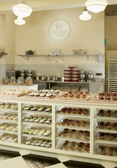 a bakery filled with lots of different types of cakes and cupcakes on display