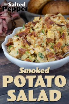 smoked potato salad in a white bowl on a wooden table with the words smoked potato salad