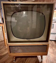 an old television sitting on top of a wooden table