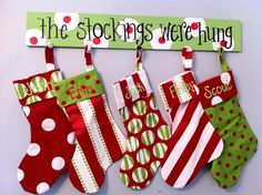 christmas stockings hanging on the wall next to a sign that says, the stocking store hung