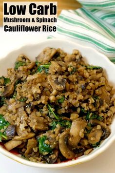 a white bowl filled with mushroom and spinach stir - fry on top of a table