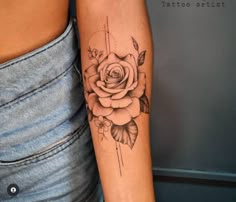 a woman's arm with a rose tattoo on it