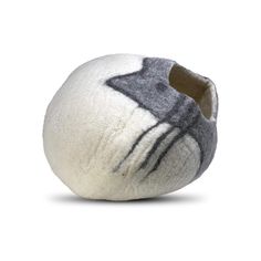 a gray and white ball with black stripes on it's side, sitting in front of a white background