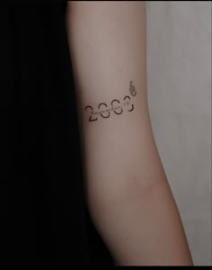 a person with a tattoo on their arm that reads 350 and has the numbers in it