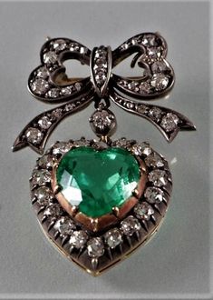 Handmade Brooch Recycling: No Silver weight: 8.590 Grams Gemstone: Rose Cut Diamond & Emerald Diamond weight: 2.89 ct Diamond colure: Tinted Brown Diamond shape: Round Natural Diamond Emerald weight: 4.23 ct Emerald: Lab created Material : Silver Silver Purity: 925 Brooch Finished: Oxidized Black & Gold plated Vintage Green Diamond Brooches, Fine Jewelry Green Brooches For Anniversary, Fine Jewelry Green Brooch For Anniversary, Green Fine Jewelry Brooch For Anniversary, Victorian Jewel Brooches As Gifts, Antique Jeweled Brooches For Gifts, Victorian Jeweled Brooches For Gifts, Victorian Jewel Brooches For Gifts, 17 Jewel Pendant Brooches For Gifts