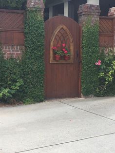 a wooden gate with potted flowers on it